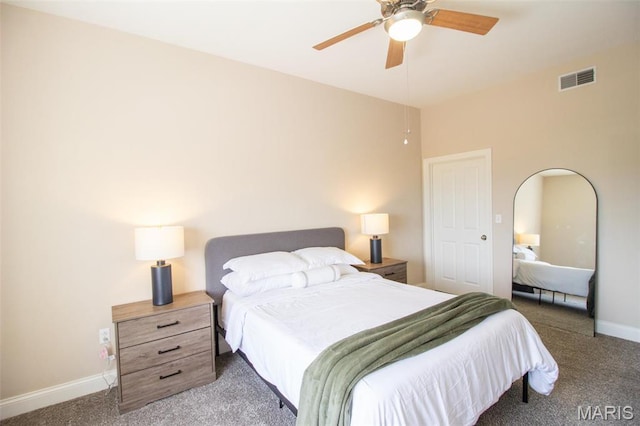 carpeted bedroom featuring baseboards, a ceiling fan, and arched walkways