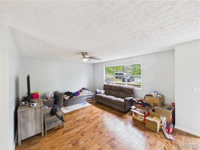 14075 Howard Ln, Dixon, MO 65459 - living area with a textured ceiling, wood finished floors, and ceiling fan