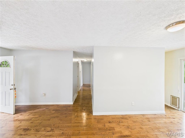14075 Howard Ln, Dixon, MO 65459 - spare room with a textured ceiling, baseboards, and wood finished floors