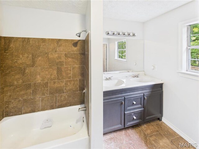 14075 Howard Ln, Dixon, MO 65459 - bathroom featuring bathing tub / shower combination, double vanity, baseboards, and a textured ceiling