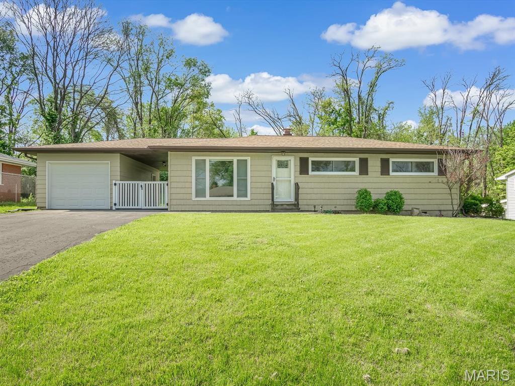 7320 Arke Dr, Belleville, IL 62223 - ranch-style house featuring a garage, asphalt driveway, and a chimney