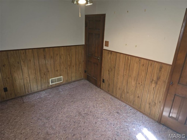 9332 Cloverhurst Dr, Saint Louis, MO 63123 - unfurnished room with wood walls, wainscoting, and a ceiling fan