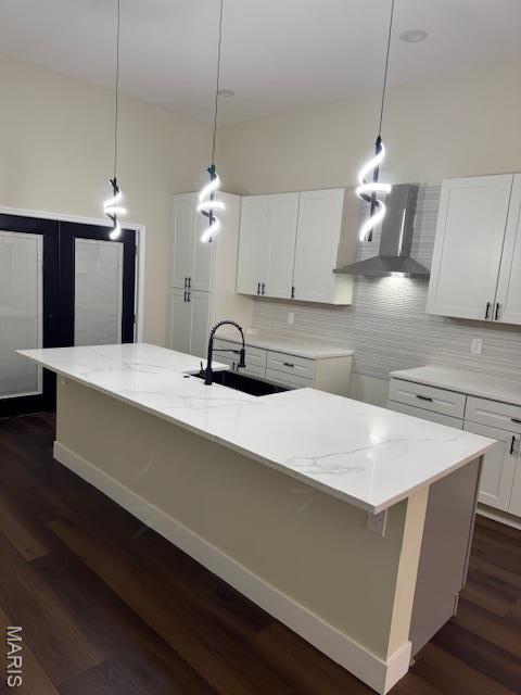 4209 Norfolk Ave, Saint Louis, MO 63110 - kitchen featuring a sink, wall chimney exhaust hood, backsplash, dark wood-type flooring, and white cabinets