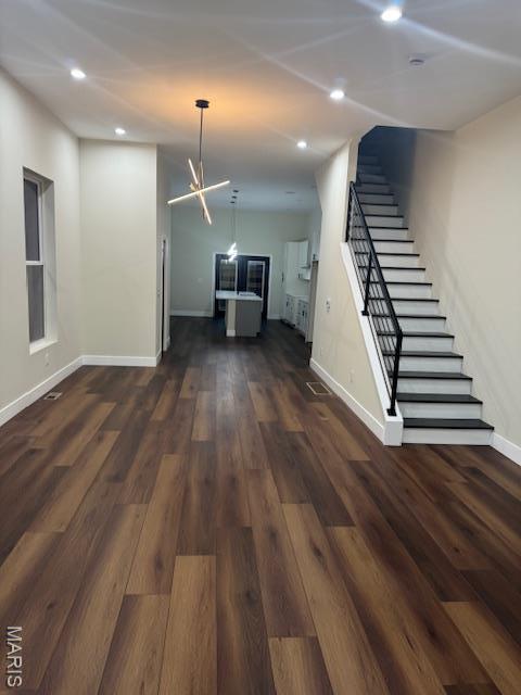 4209 Norfolk Ave, Saint Louis, MO 63110 - unfurnished living room featuring stairway, baseboards, recessed lighting, and dark wood finished floors