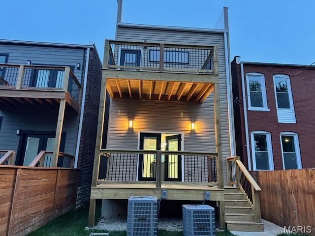 4209 Norfolk Ave, Saint Louis, MO 63110 - back of property with a balcony, fence, and central AC