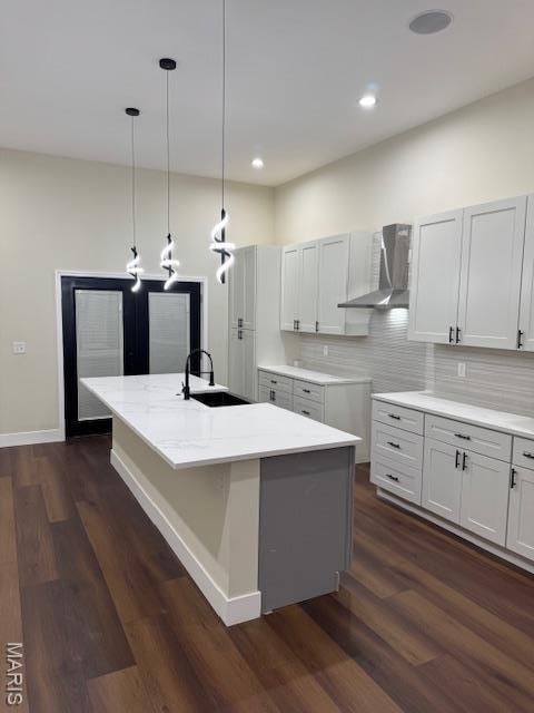 4209 Norfolk Ave, Saint Louis, MO 63110 - kitchen with wall chimney exhaust hood, a sink, dark wood-style floors, a kitchen island with sink, and tasteful backsplash