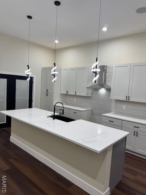 4209 Norfolk Ave, Saint Louis, MO 63110 - kitchen featuring a sink, dark wood-style flooring, wall chimney exhaust hood, decorative backsplash, and pendant lighting