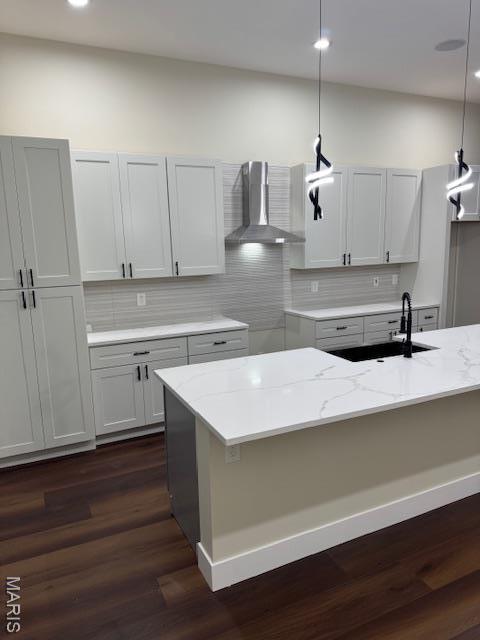 4209 Norfolk Ave, Saint Louis, MO 63110 - kitchen featuring wall chimney exhaust hood, a sink, light stone countertops, dark wood-style floors, and recessed lighting