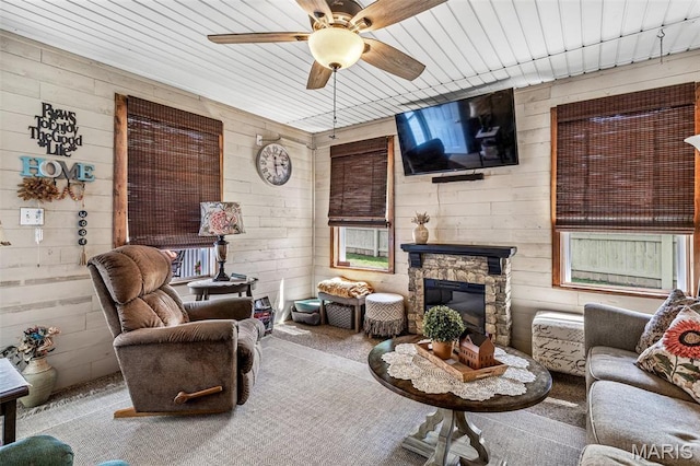 111 Edwards Ln, Park Hills, MO 63601 - carpeted living area featuring a ceiling fan, wood walls, and a fireplace