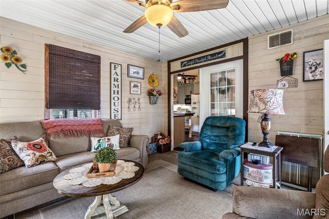 111 Edwards Ln, Park Hills, MO 63601 - carpeted living area with wood walls and a ceiling fan