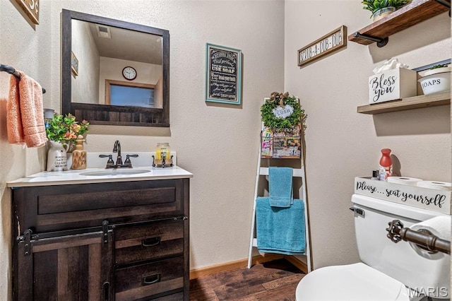 111 Edwards Ln, Park Hills, MO 63601 - half bath featuring wood finished floors, vanity, toilet, a textured wall, and baseboards