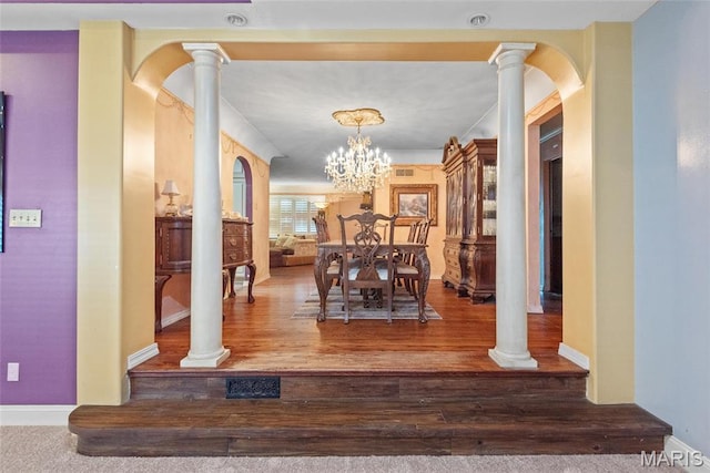 2048 Pontoon Rd, Granite City, IL 62040 - hallway featuring ornate columns, wood finished floors, arched walkways, baseboards, and a chandelier