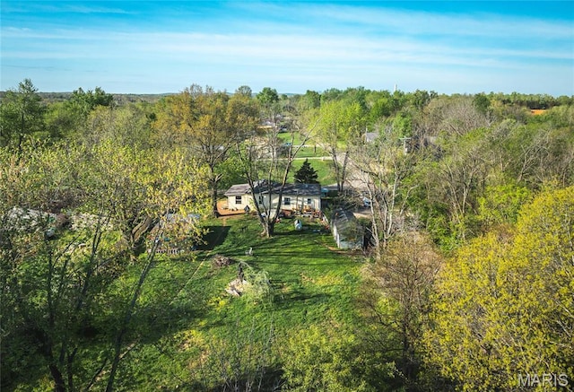 view of subject property featuring a forest