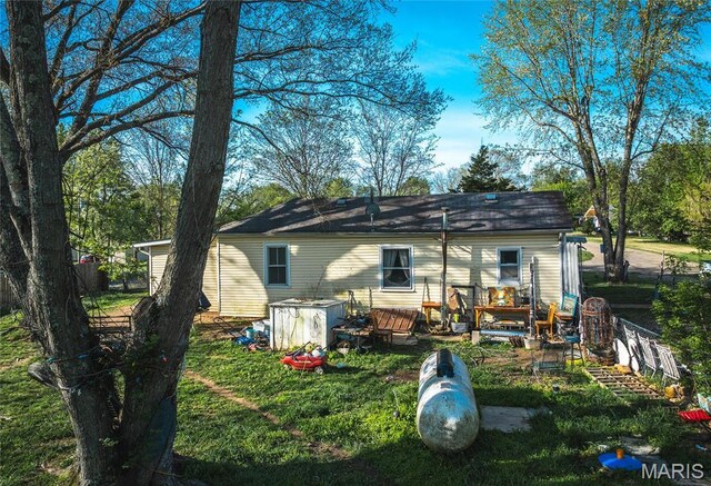 rear view of property featuring a wooden deck