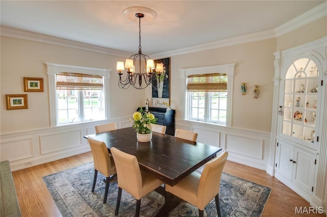 1210 Mckinley Blvd, Alton, IL 62002 - dining space featuring a chandelier, a wainscoted wall, ornamental molding, a decorative wall, and light wood-type flooring