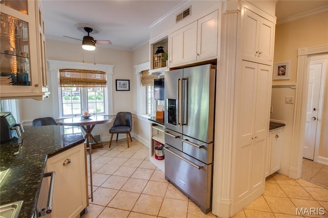 1210 Mckinley Blvd, Alton, IL 62002 - kitchen with high end fridge, crown molding, light tile patterned floors, ceiling fan, and dark stone countertops