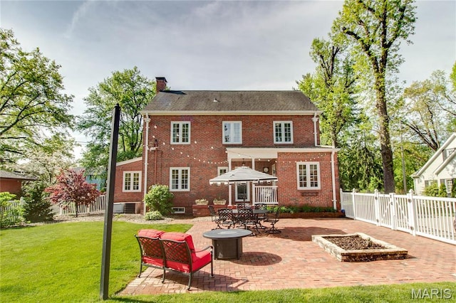 1210 Mckinley Blvd, Alton, IL 62002 - back of house featuring a patio, brick siding, a chimney, and a fire pit