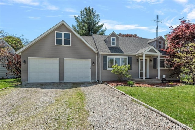 714 W Elm St, Taylorville, IL 62568 - new england style home featuring gravel driveway, a front yard, a shingled roof, and an attached garage