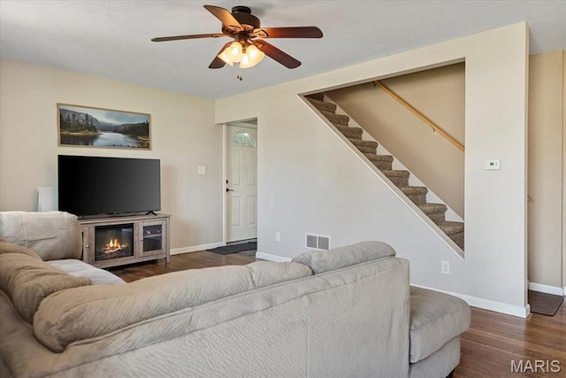 714 W Elm St, Taylorville, IL 62568 - living room featuring wood finished floors, stairs, baseboards, and a ceiling fan