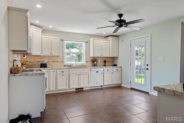 714 W Elm St, Taylorville, IL 62568 - kitchen featuring backsplash, a sink, dishwasher, dark tile patterned flooring, and recessed lighting