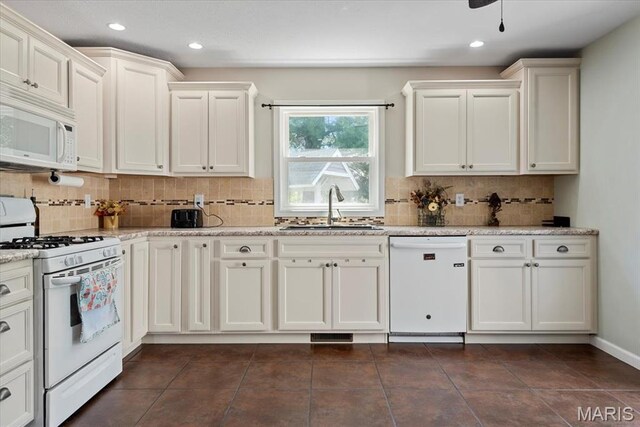 714 W Elm St, Taylorville, IL 62568 - kitchen featuring white appliances, a sink, decorative backsplash, white cabinets, and recessed lighting