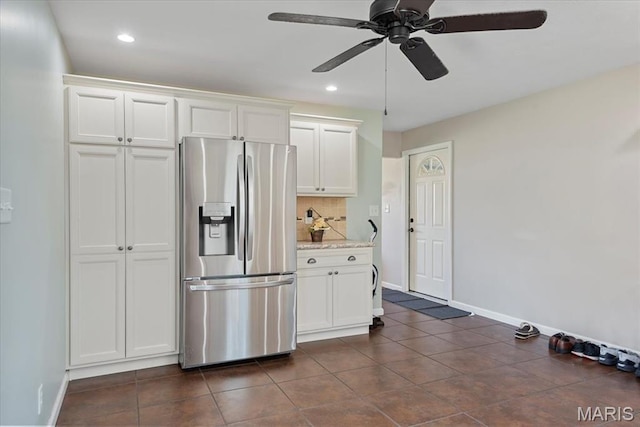 714 W Elm St, Taylorville, IL 62568 - kitchen with stainless steel refrigerator with ice dispenser, baseboards, white cabinets, and recessed lighting