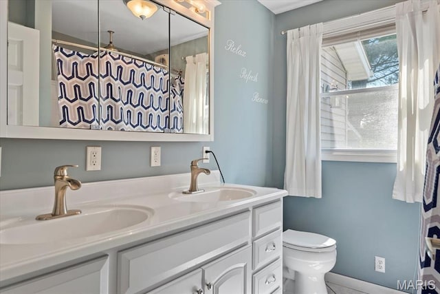 714 W Elm St, Taylorville, IL 62568 - bathroom with double vanity and toilet