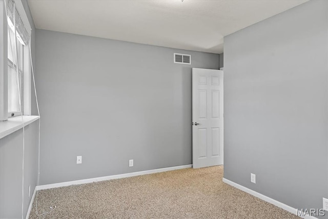 714 W Elm St, Taylorville, IL 62568 - empty room featuring carpet and baseboards