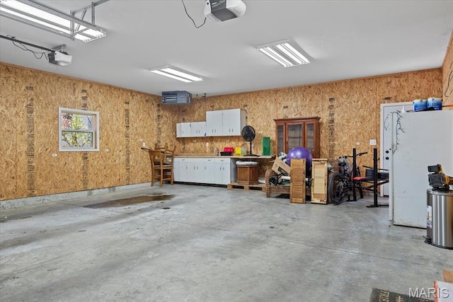714 W Elm St, Taylorville, IL 62568 - garage featuring a garage door opener and a workshop area