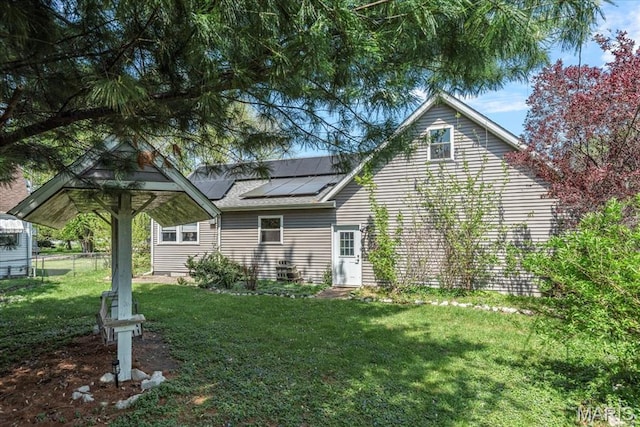 714 W Elm St, Taylorville, IL 62568 - back of house with roof mounted solar panels and a yard