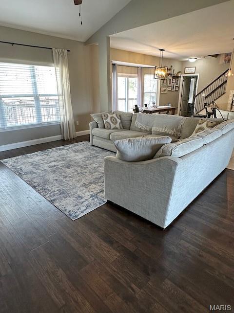 203 Chadwyck Cir, Herculaneum, MO 63048 - living room with stairway, a chandelier, dark wood-style flooring, lofted ceiling, and baseboards
