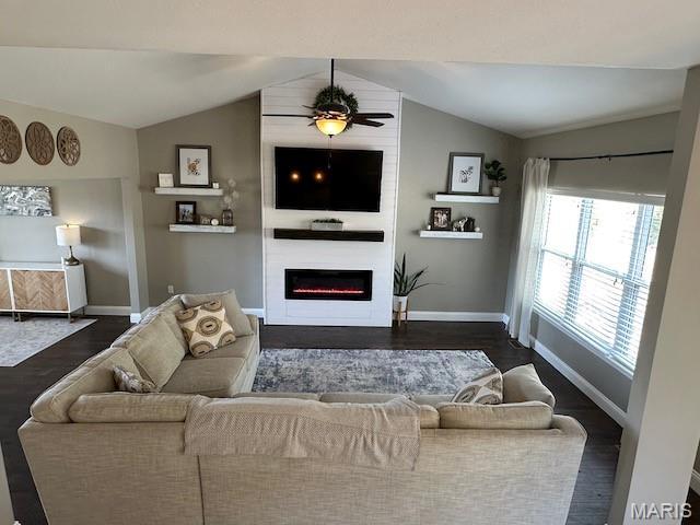 203 Chadwyck Cir, Herculaneum, MO 63048 - living room featuring vaulted ceiling, baseboards, a large fireplace, dark wood finished floors, and plenty of natural light