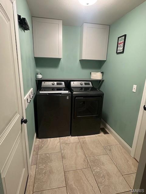 203 Chadwyck Cir, Herculaneum, MO 63048 - laundry room featuring cabinet space, washer and dryer, and baseboards
