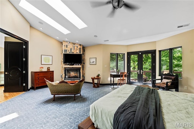 400 Gabriel Dr, Kirkwood, MO 63122 - bedroom with access to exterior, a skylight, vaulted ceiling, a stone fireplace, and multiple windows