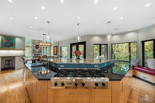 400 Gabriel Dr, Kirkwood, MO 63122 - kitchen featuring stainless steel gas stovetop, recessed lighting, light wood-type flooring, a large island, and dark stone countertops