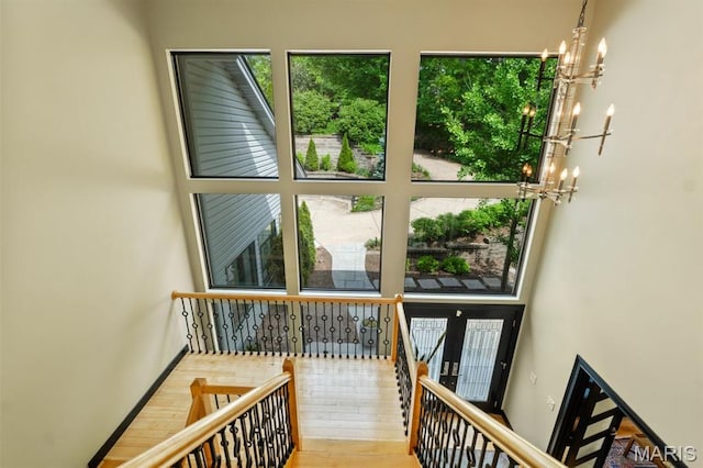 400 Gabriel Dr, Kirkwood, MO 63122 - stairway featuring a chandelier, wood finished floors, and a towering ceiling