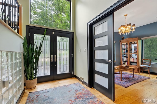 400 Gabriel Dr, Kirkwood, MO 63122 - foyer entrance featuring french doors, a chandelier, and wood finished floors