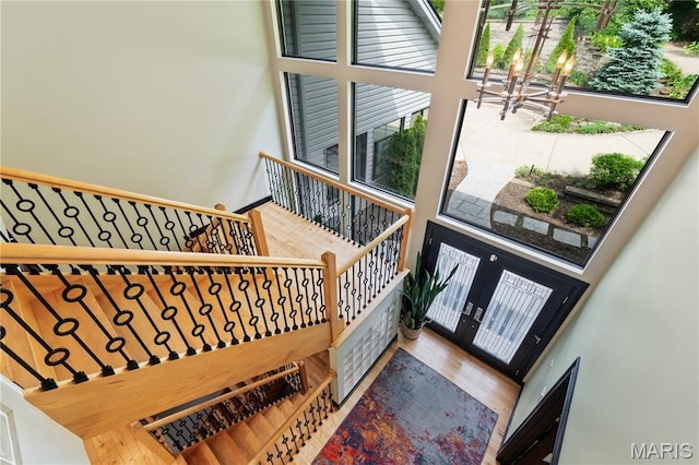 400 Gabriel Dr, Kirkwood, MO 63122 - staircase with a chandelier, wood finished floors, and a high ceiling