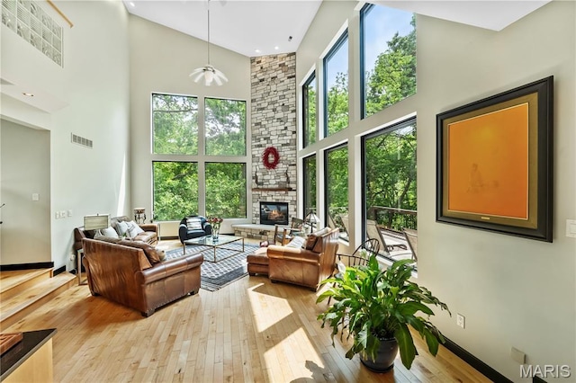 400 Gabriel Dr, Kirkwood, MO 63122 - living room featuring a high ceiling, hardwood / wood-style flooring, a fireplace, and ceiling fan