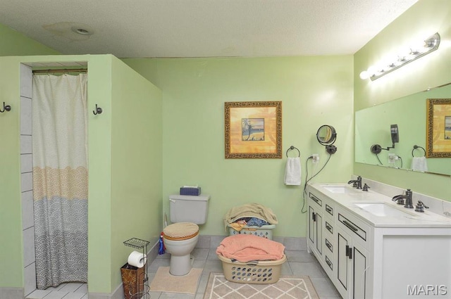 full bathroom with toilet, tile patterned floors, double vanity, curtained shower, and a textured ceiling
