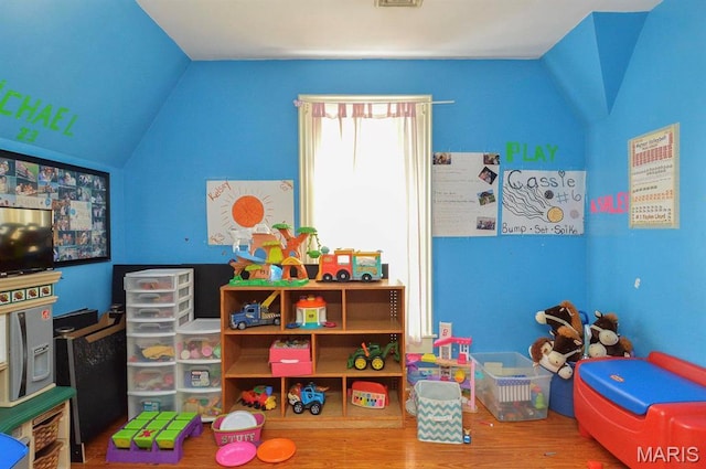 game room featuring vaulted ceiling and wood finished floors