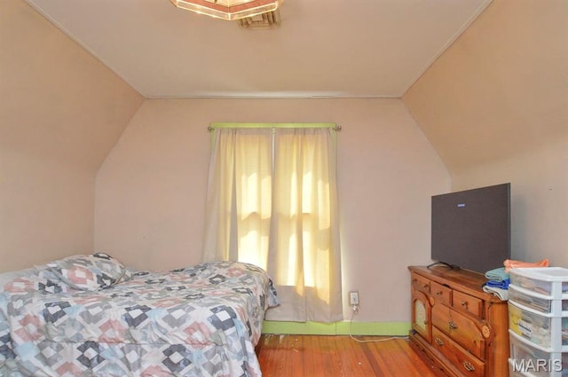 bedroom featuring vaulted ceiling and wood finished floors