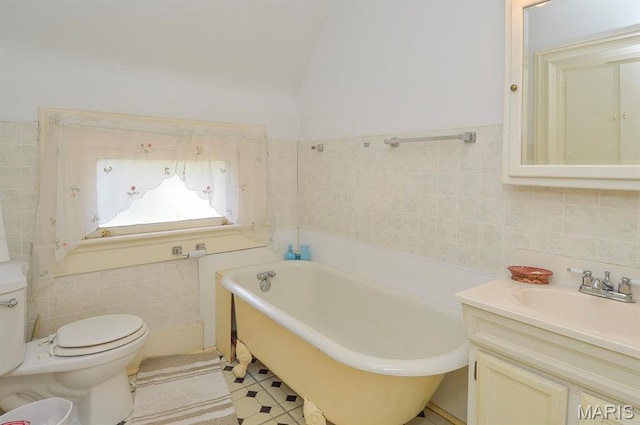 full bathroom with tile walls, toilet, a bathtub, and vanity