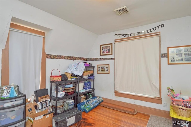 recreation room featuring wood finished floors and lofted ceiling