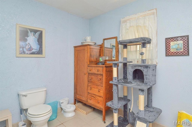 bathroom with toilet and tile patterned floors