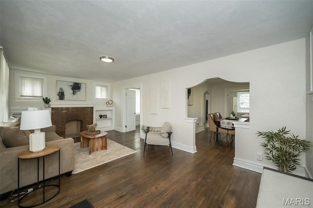 4117 Ravenwood Ave, Saint Louis, MO 63121 - living room featuring wood finished floors, baseboards, and a fireplace