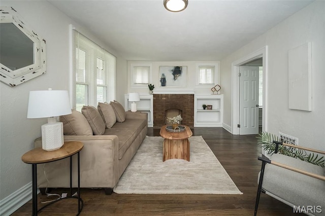 4117 Ravenwood Ave, Saint Louis, MO 63121 - living room featuring plenty of natural light, dark wood-style flooring, baseboards, and a fireplace