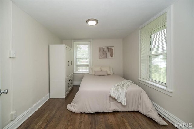 4117 Ravenwood Ave, Saint Louis, MO 63121 - bedroom with dark wood-type flooring and baseboards