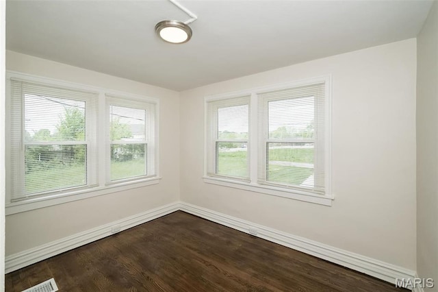 4117 Ravenwood Ave, Saint Louis, MO 63121 - unfurnished room featuring baseboards and dark wood-type flooring