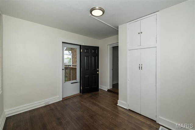4117 Ravenwood Ave, Saint Louis, MO 63121 - unfurnished bedroom with dark wood-style floors and baseboards